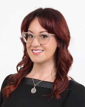 Woman with red hair in a black dress