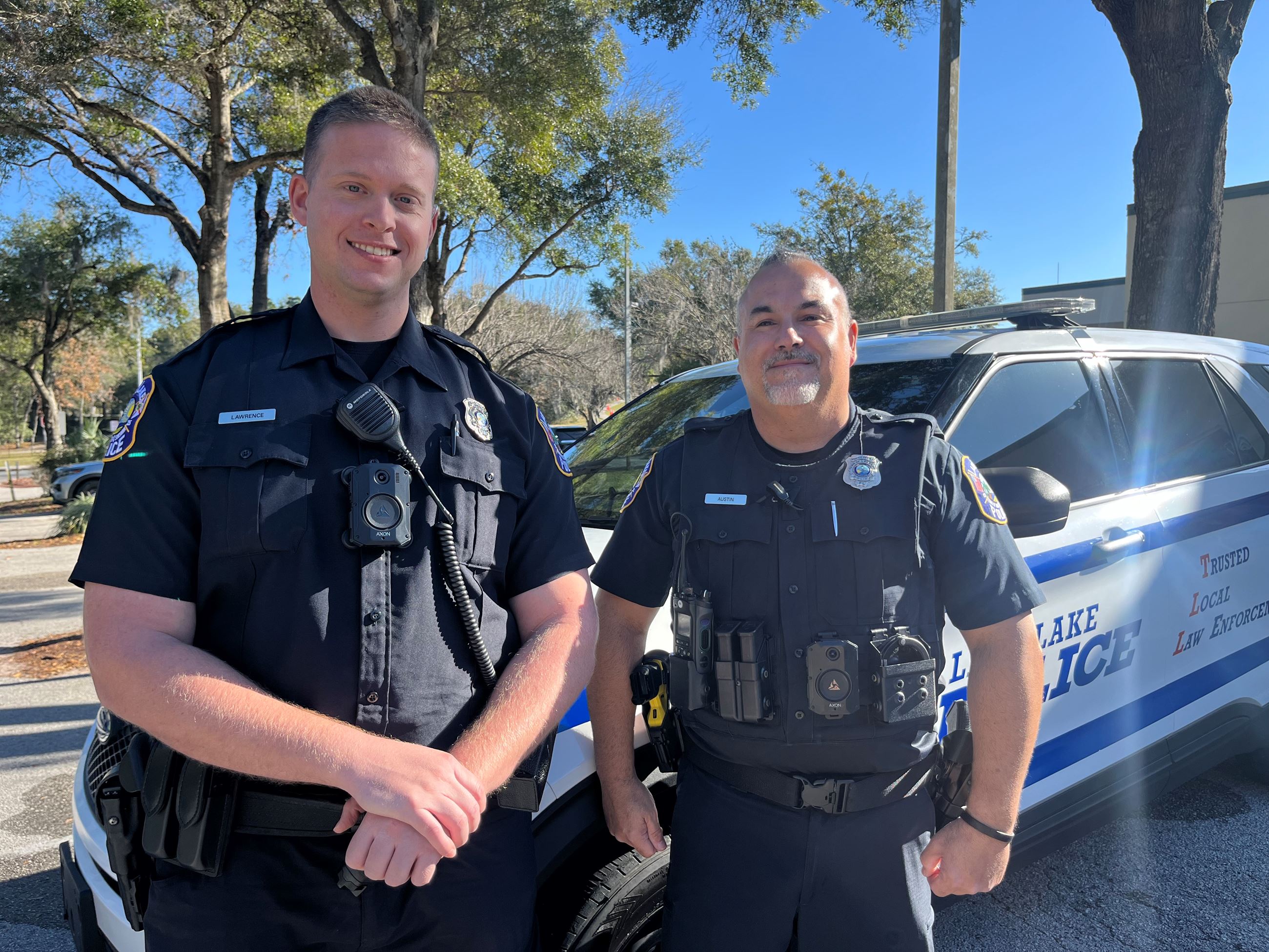 Two male officers wearing body cameras