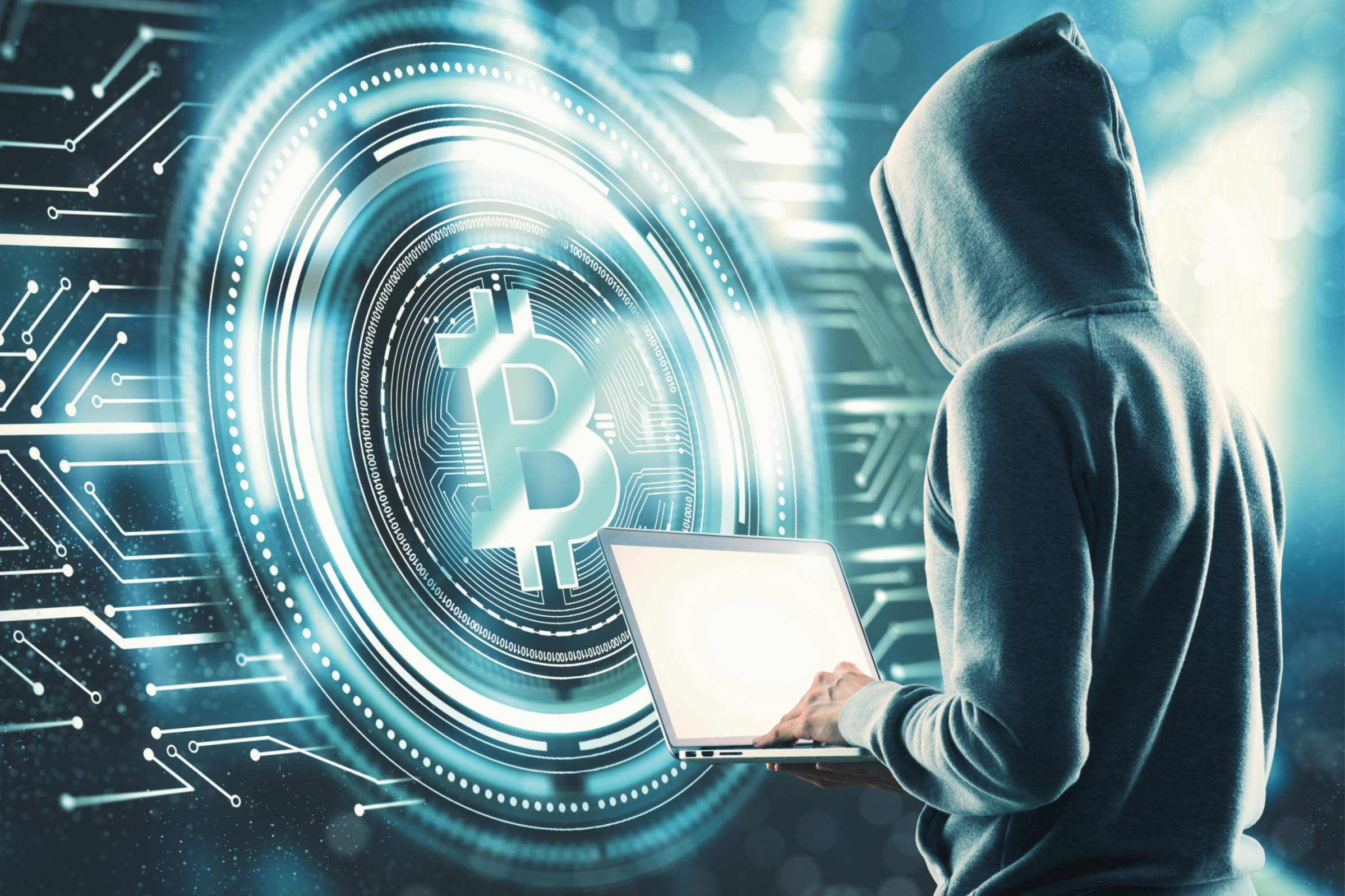 Graphic image of man in a hood with a laptop with Bitcoin symbol