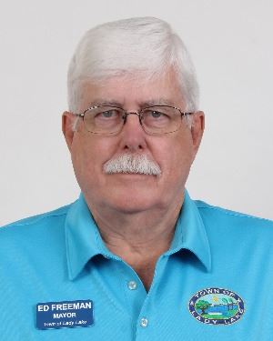 Man with a mustache wearing a blue shirt