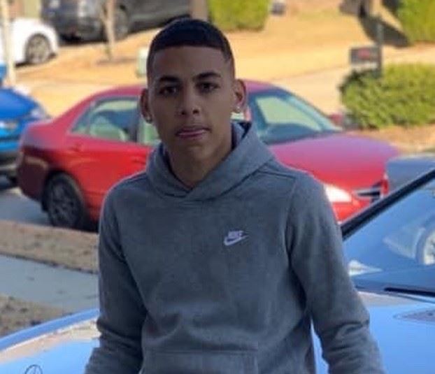 Young man with short hair wearing a gray sweatshirt